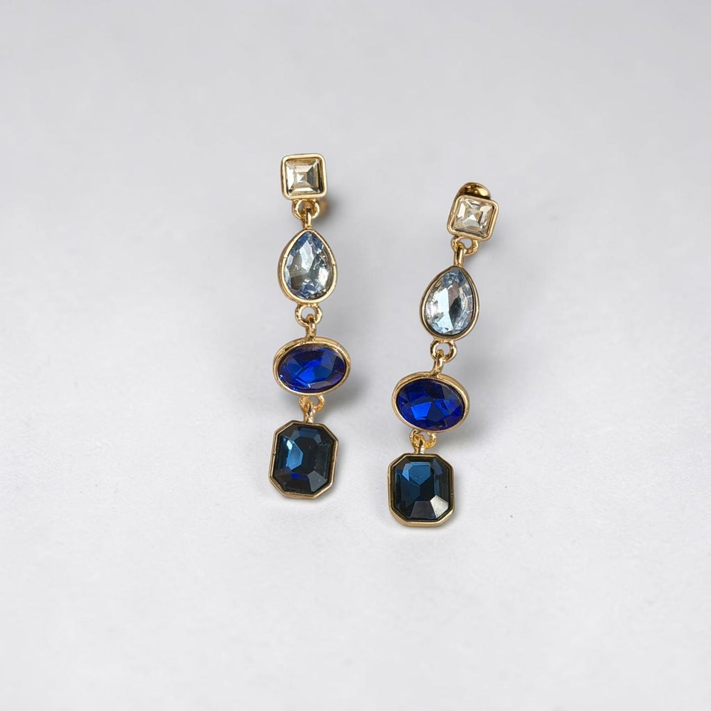 Sapphire Blue Four-Stone Drop Earrings Gold Tone — styled with neutral outfit