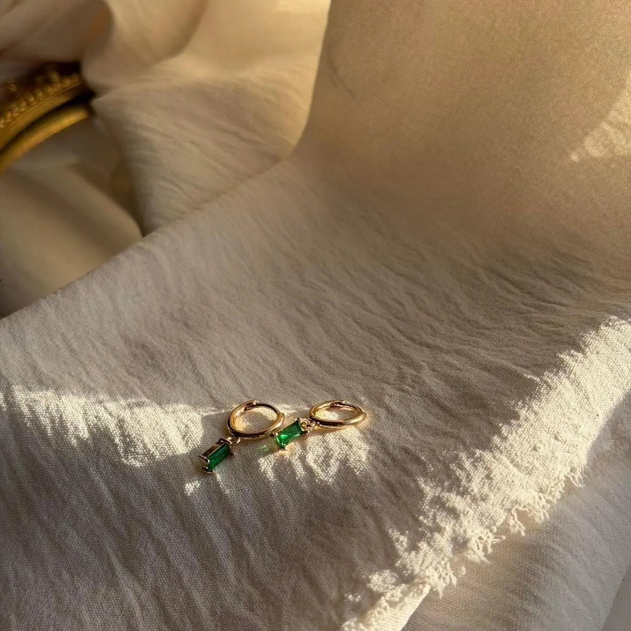 Emerald Baguette Crystal Huggie Hoop Earrings 14K — angle highlighting drop and movement