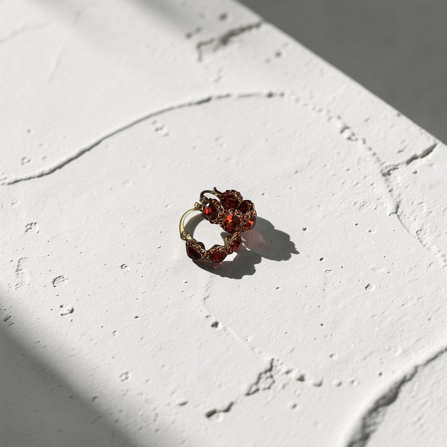 Red Crystal Pavé Huggie Hoop Earrings S925 Gold — angle highlighting drop and movement