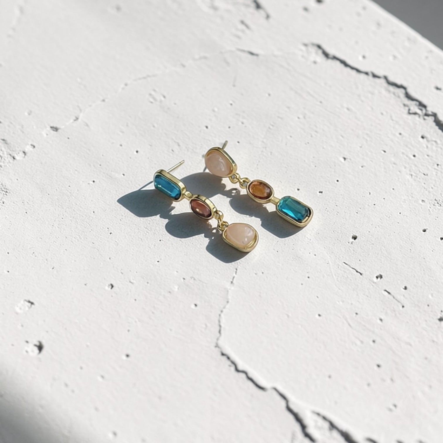 Asymmetric Triple Stone Cascade Drop Earrings S925 on neutral background — front view