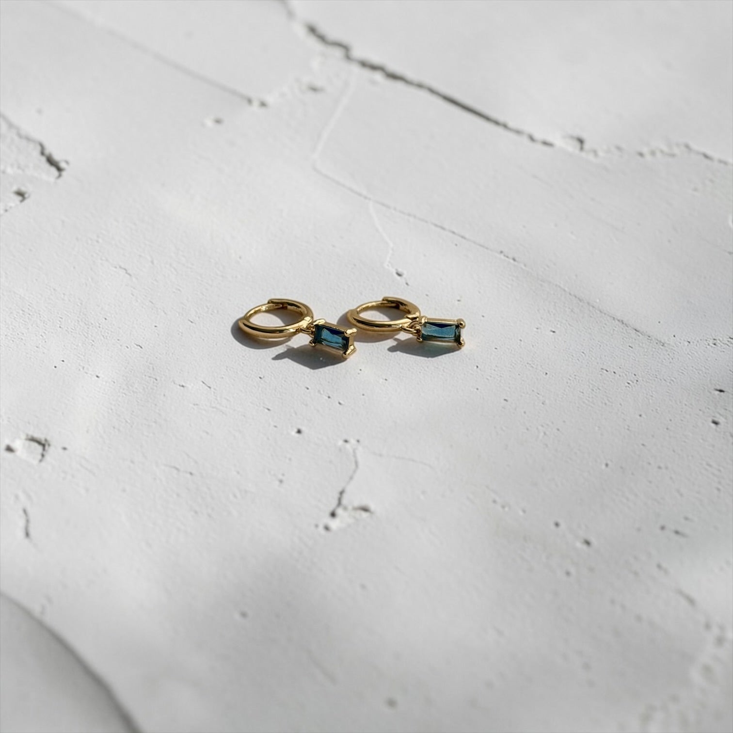 Baguette Blue Crystal Huggie Hoop Earrings 14K Gold — styled with neutral outfit