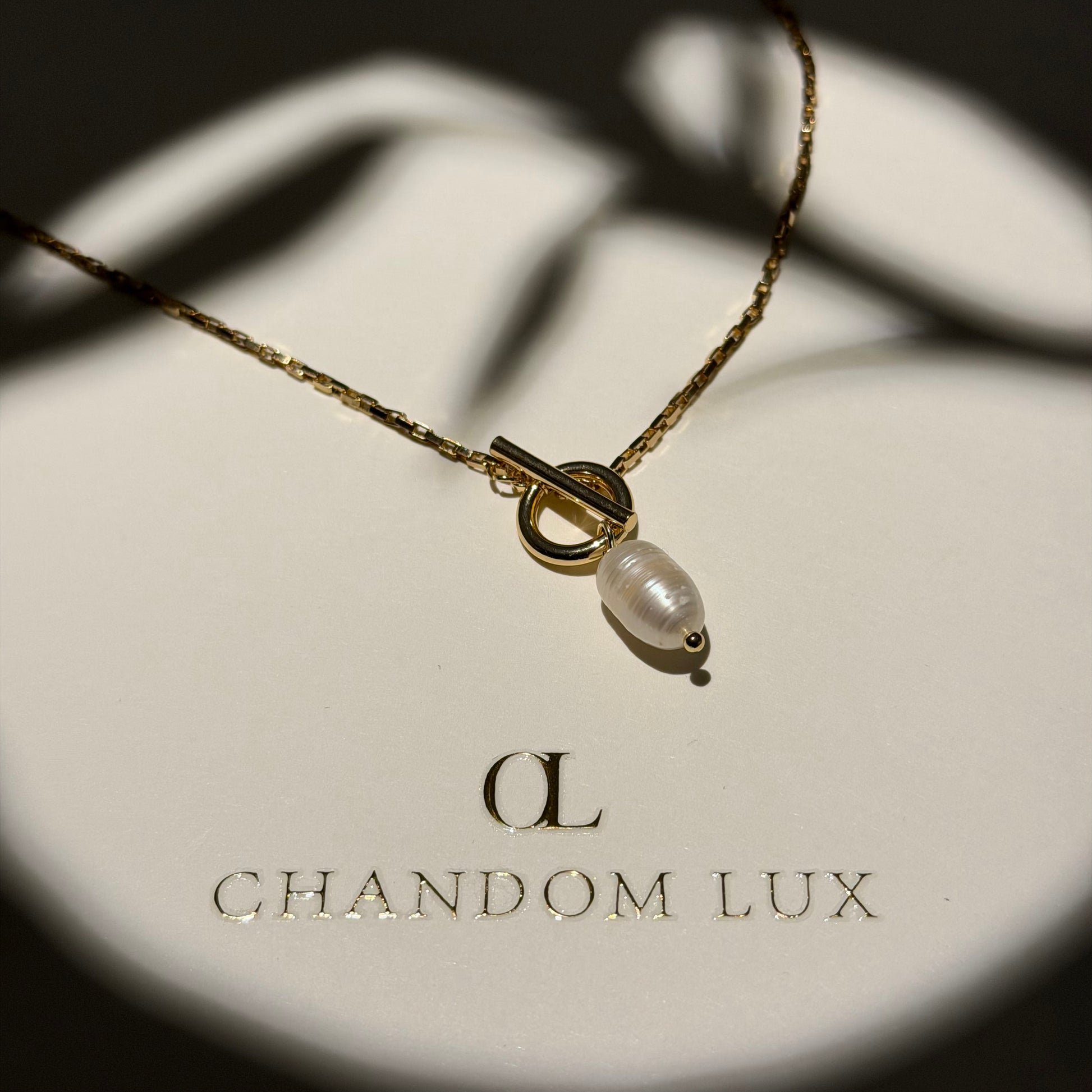 Baroque Freshwater Pearl Toggle Pendant Necklace — styled flat lay with textures