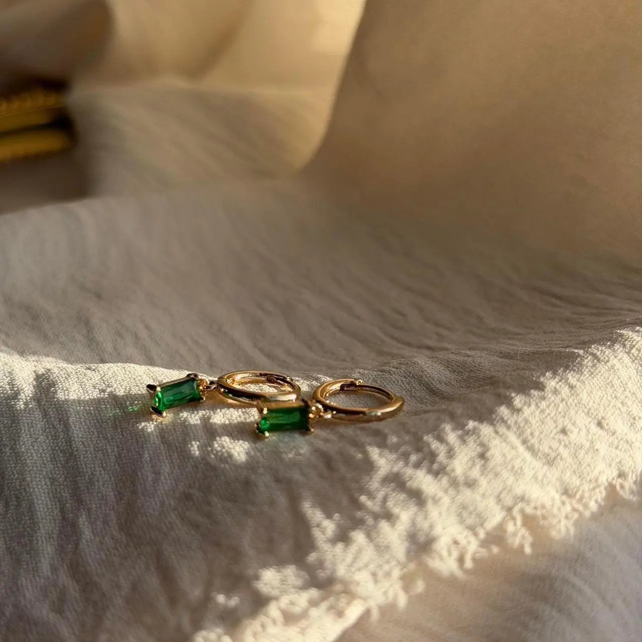 Emerald Baguette Crystal Huggie Hoop Earrings 14K — pair shown together on flat lay