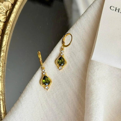 Olive Green Crystal Huggie Drop Earrings Gold Tone — pair shown together on flat lay