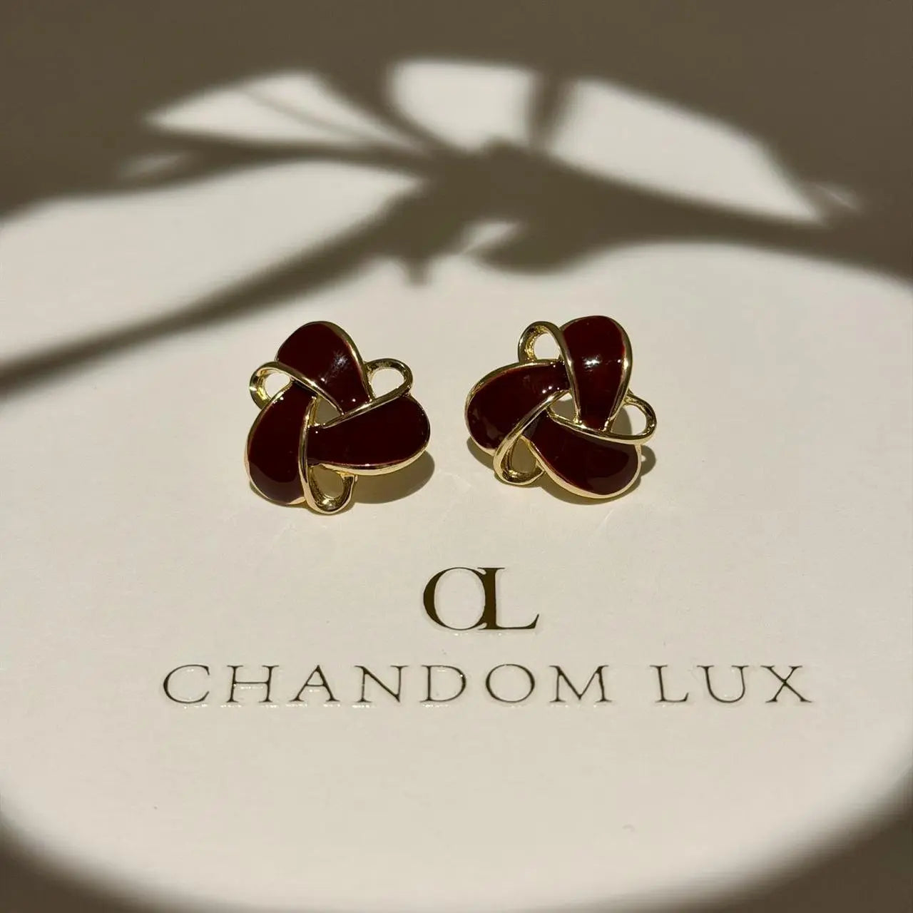 Burgundy Enamel Knot Stud Earrings S925 Gold Tone on neutral background — front view