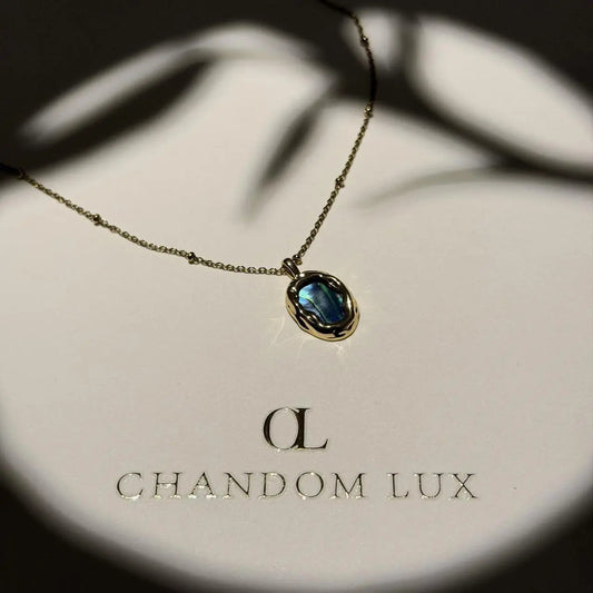 Abalone Shell Pendant Necklace Gold Satellite Chain on neutral background — full length view