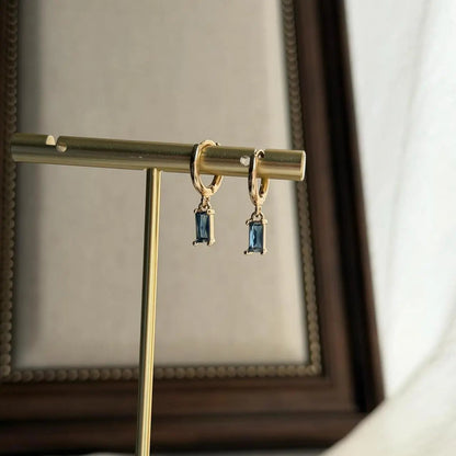 Baguette Blue Crystal Huggie Hoop Earrings 14K Gold — worn on model, side profile