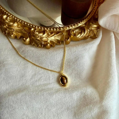 Natural Tiger Eye Oval Pendant Necklace Gold Plated — worn on model