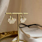 White Petal Flower Huggie Drop Earrings Gold Alloy on neutral background — front view