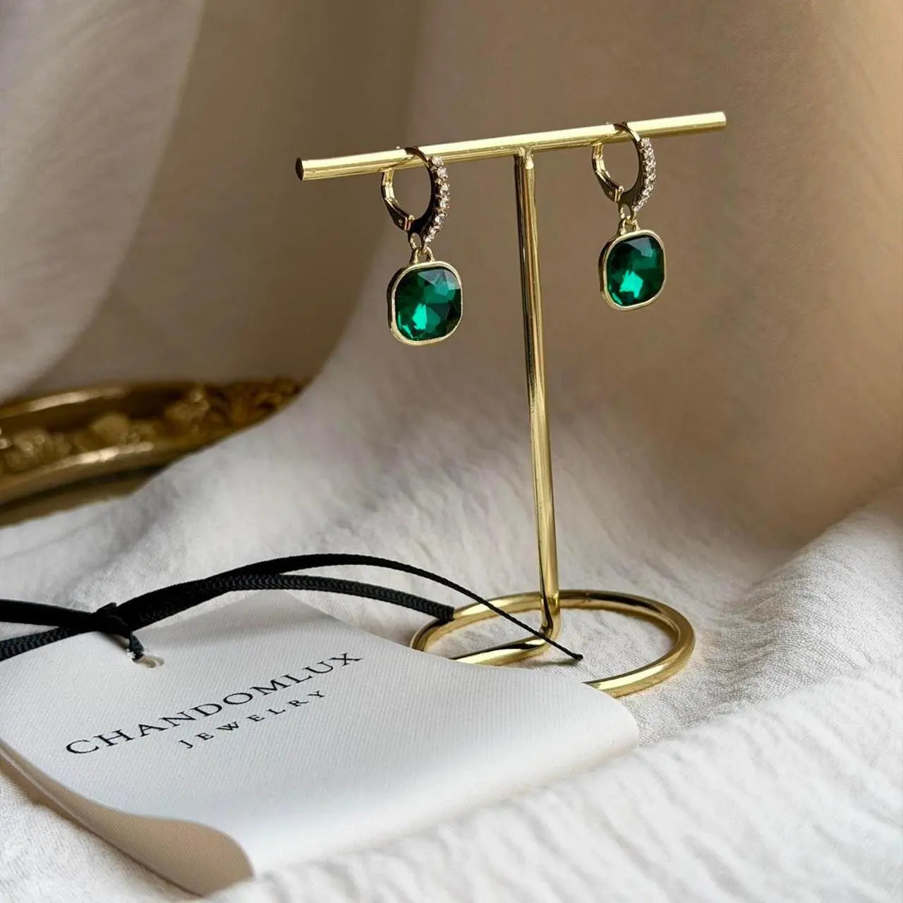 Emerald Green Cushion Crystal Drop Earrings Gold on neutral background — front view