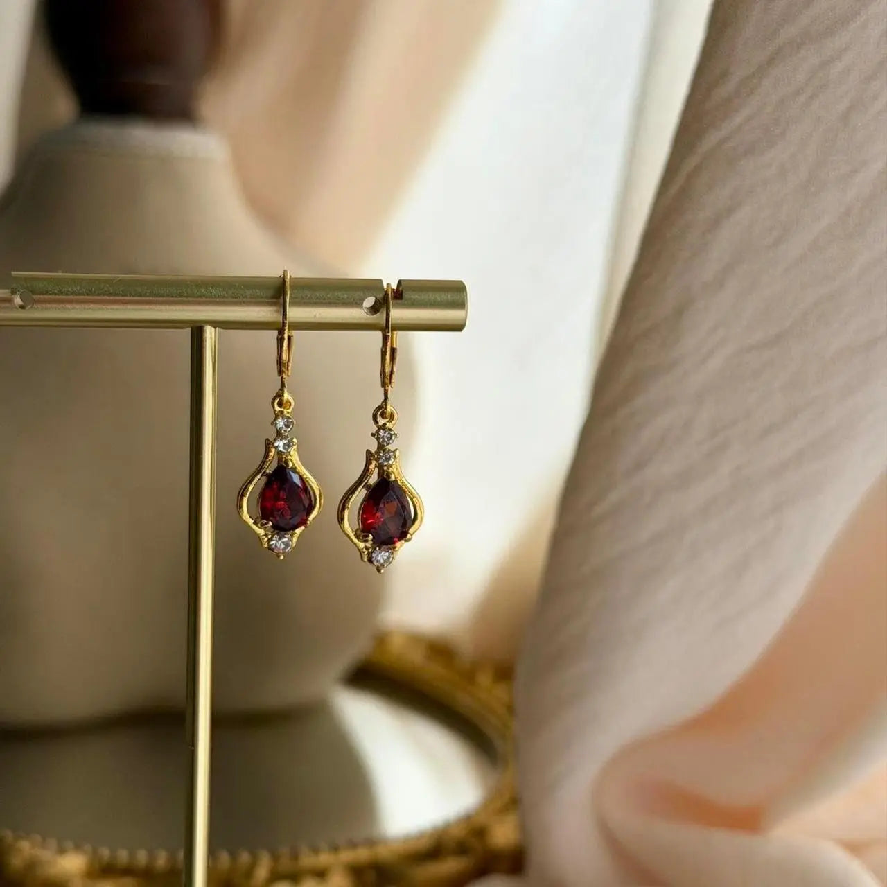 Ruby Red Crystal Huggie Drop Earrings Gold Tone — pair shown together on flat lay