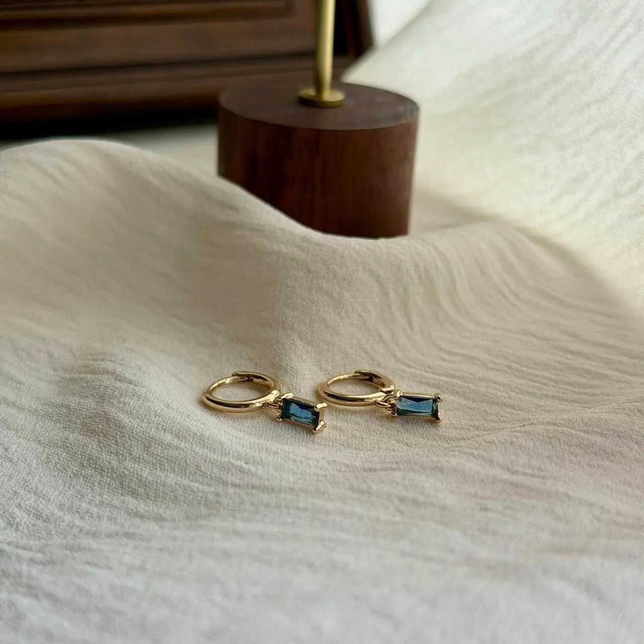 Baguette Blue Crystal Huggie Hoop Earrings 14K Gold — pair shown together on flat lay