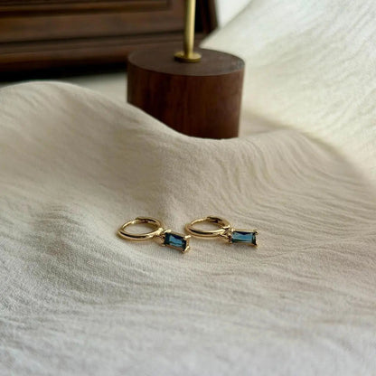 Baguette Blue Crystal Huggie Hoop Earrings 14K Gold — pair shown together on flat lay