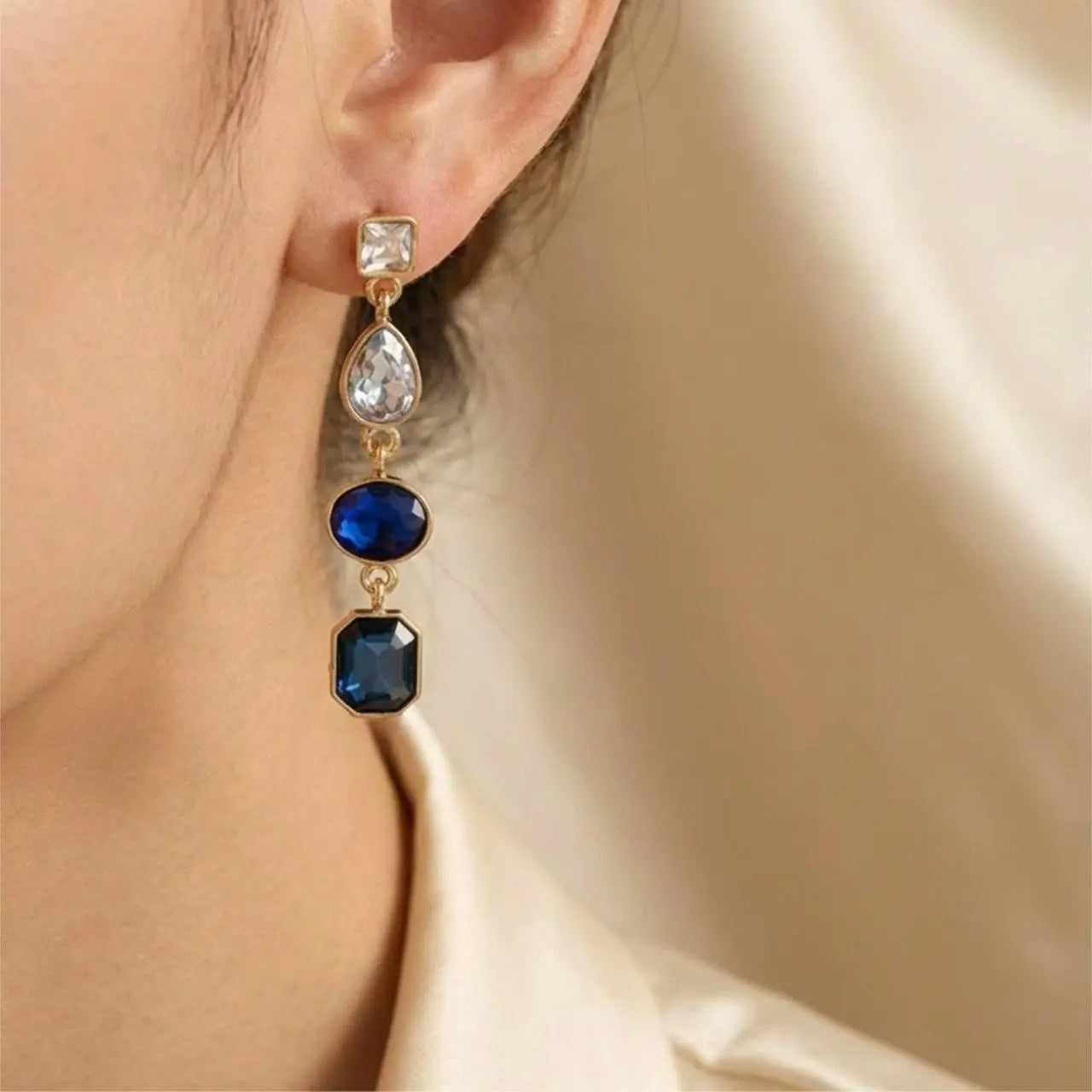 Sapphire Blue Four-Stone Drop Earrings Gold Tone — pair shown together on flat lay