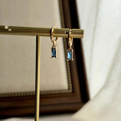Baguette Blue Crystal Huggie Hoop Earrings 14K Gold — angle highlighting drop and movement