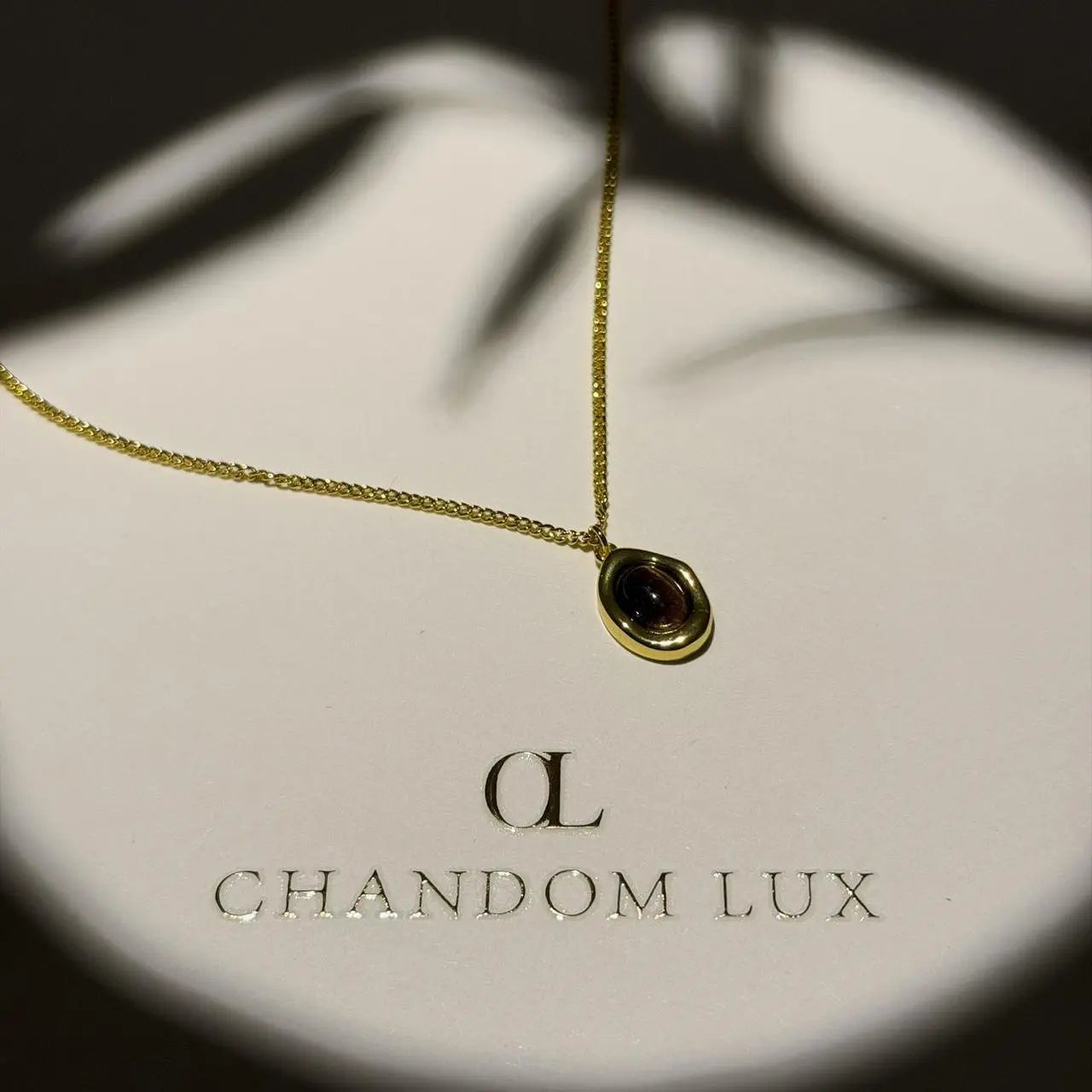 Natural Tiger Eye Oval Pendant Necklace Gold Plated — styled flat lay with textures