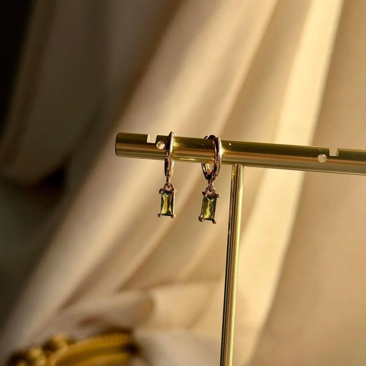 Olive Green Baguette Crystal Huggie Earrings 14K — close-up of pearl and post detail