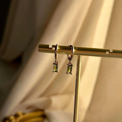 Olive Green Baguette Crystal Huggie Earrings 14K — close-up of pearl and post detail