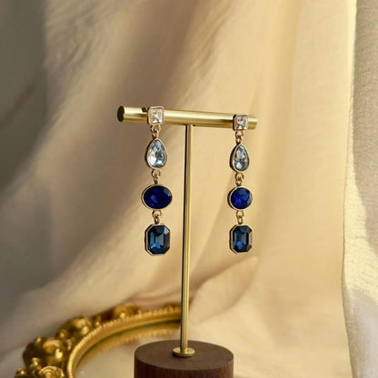 Sapphire Blue Four-Stone Drop Earrings Gold Tone on neutral background — front view