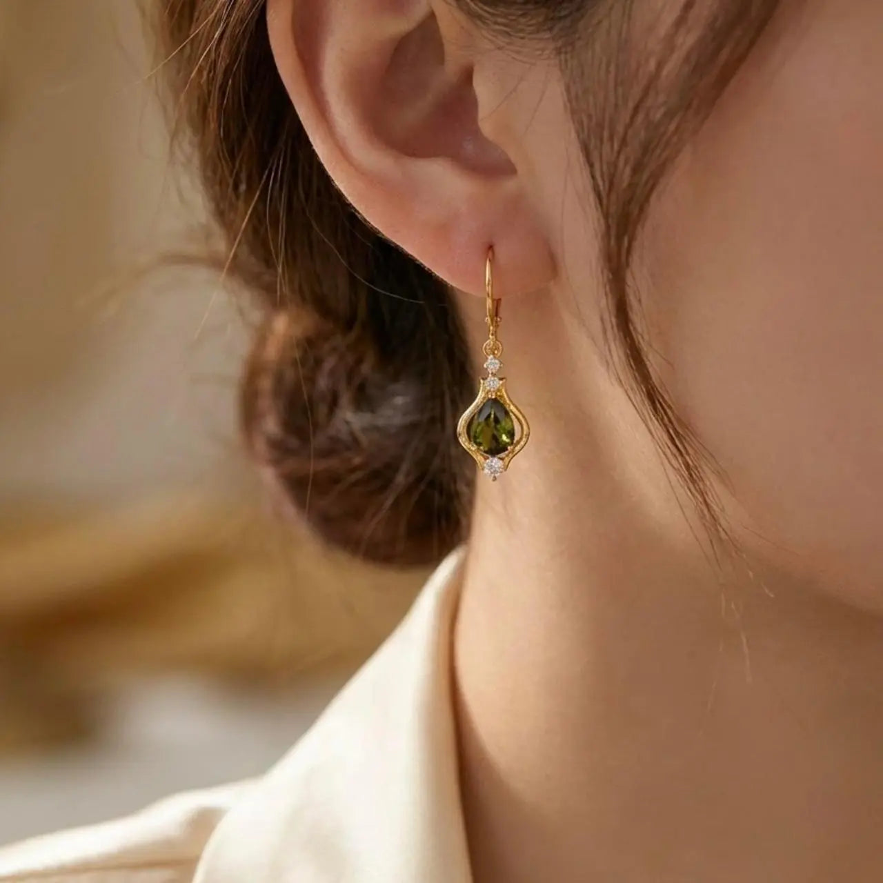 Olive Green Crystal Huggie Drop Earrings Gold Tone — angle highlighting drop and movement