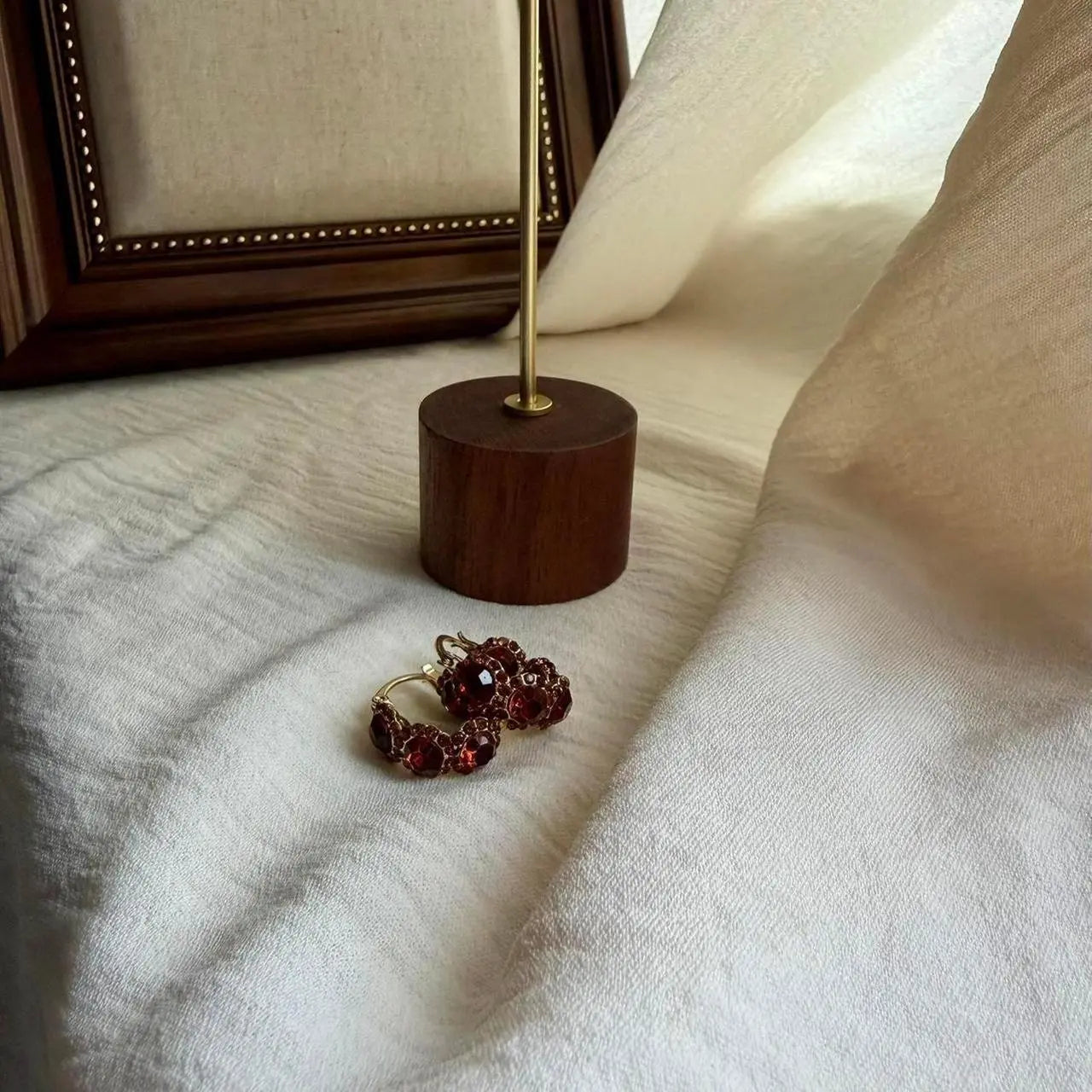 Red Crystal Pavé Huggie Hoop Earrings S925 Gold — worn on model, side profile