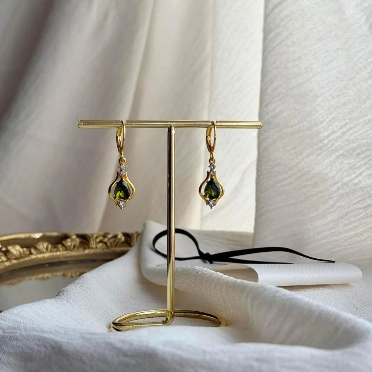Olive Green Crystal Huggie Drop Earrings Gold Tone on neutral background — front view