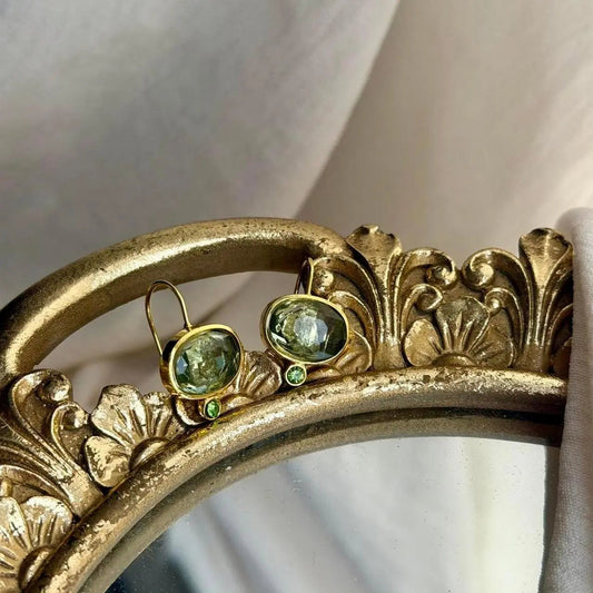 Grey Crystal & Green Accent Drop Earrings Gold on neutral background — front view
