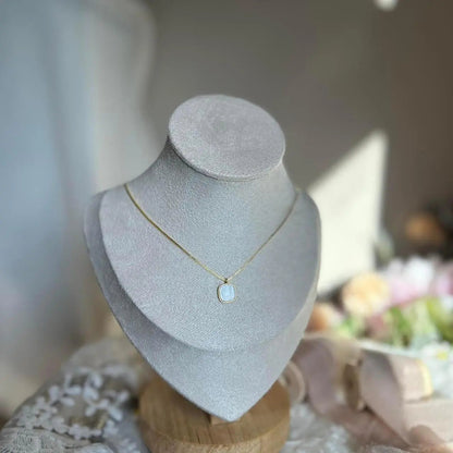Mother of Pearl Cushion Pendant Necklace Gold Tone — styled flat lay with textures