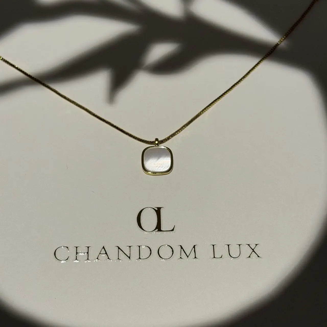 Mother of Pearl Cushion Pendant Necklace Gold Tone on neutral background — full length view