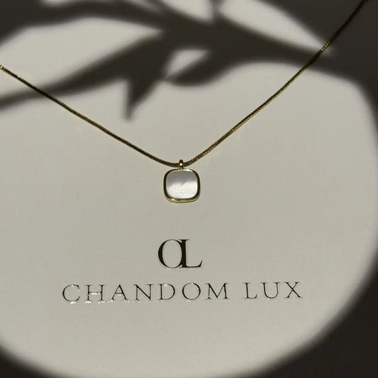 Mother of Pearl Cushion Pendant Necklace Gold Tone on neutral background — full length view