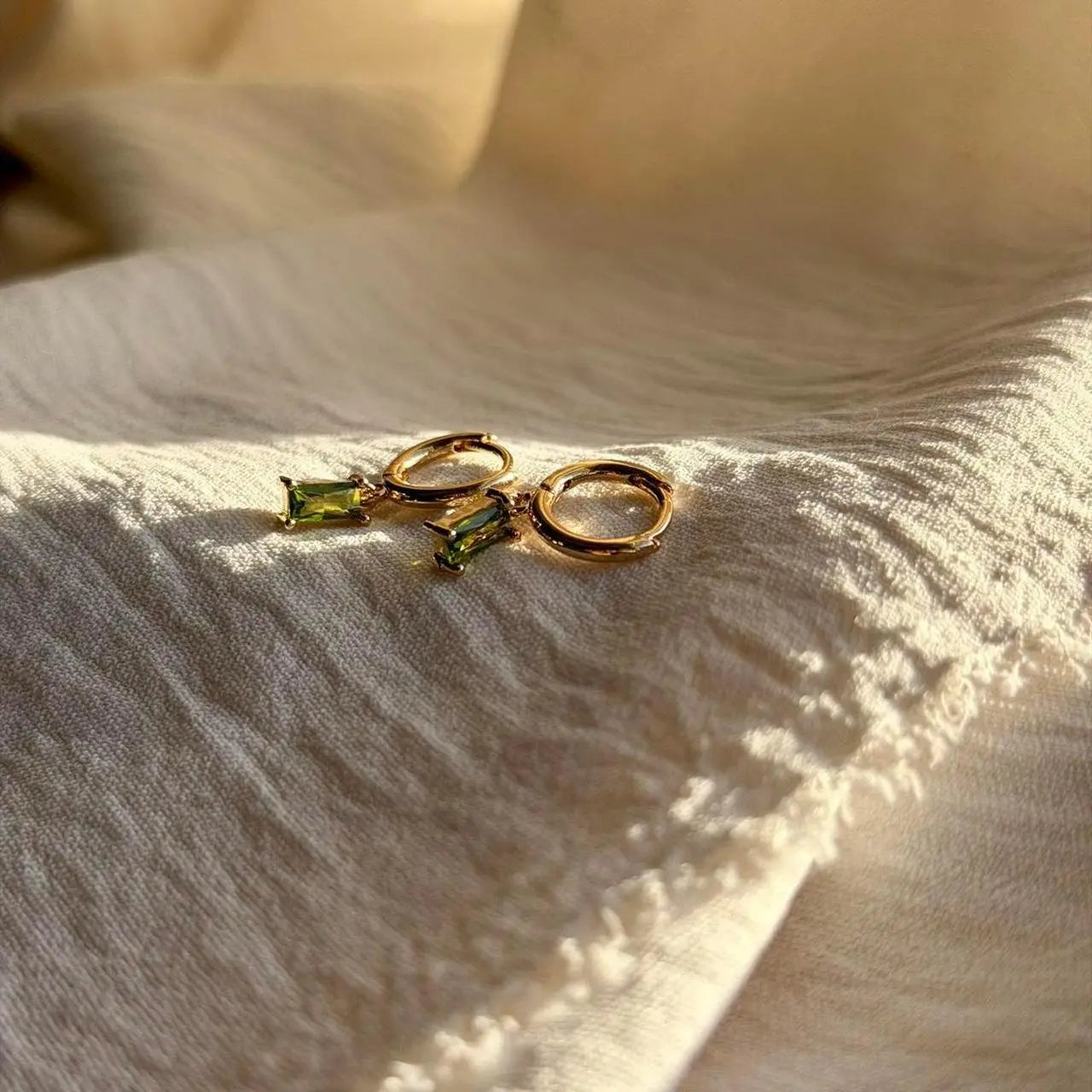 Olive Green Baguette Crystal Huggie Earrings 14K — worn on model, side profile