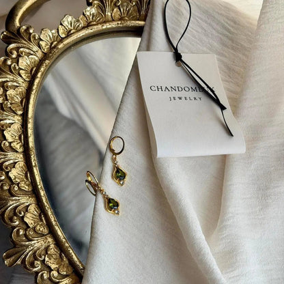 Olive Green Crystal Huggie Drop Earrings Gold Tone — worn on model, side profile