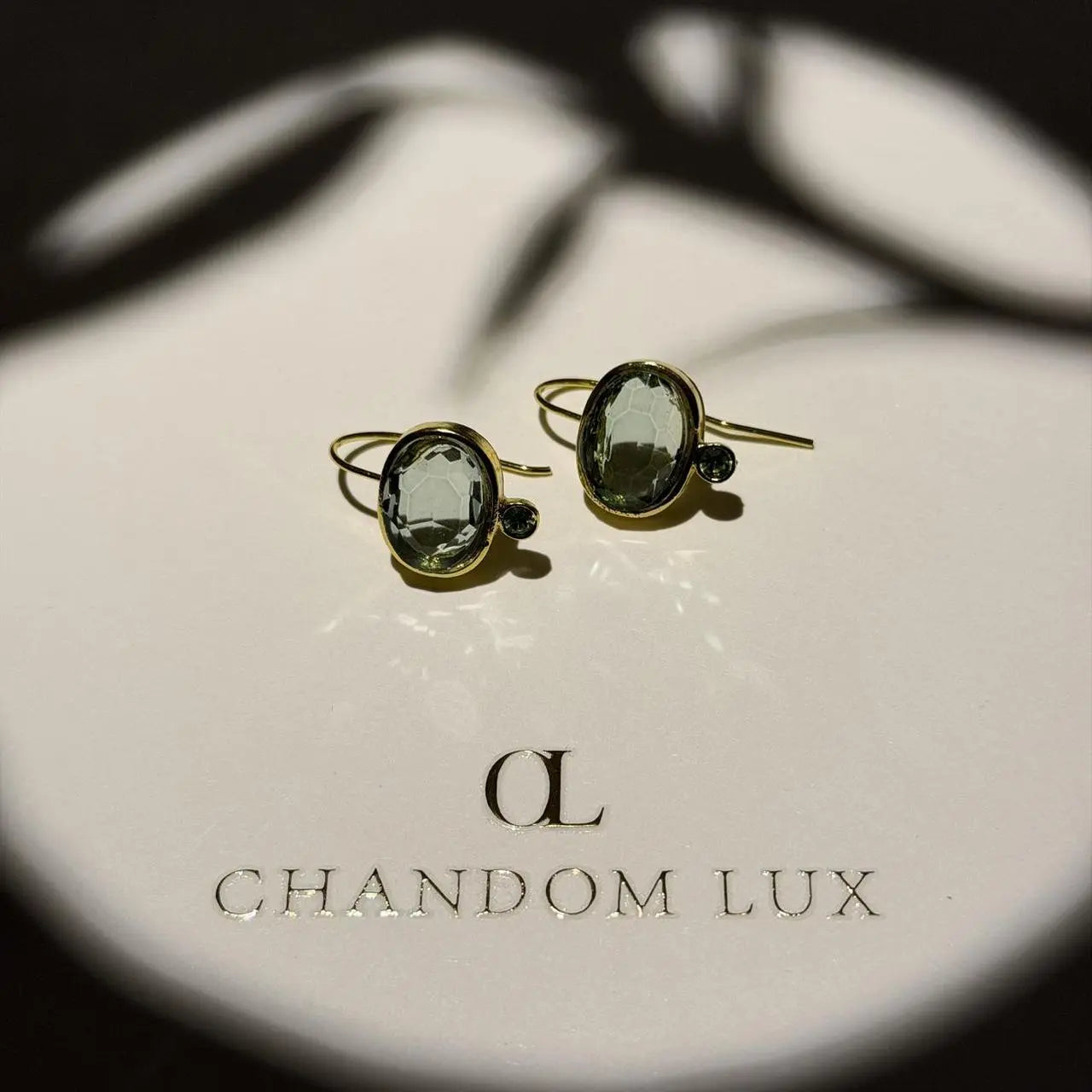 Grey Crystal & Green Accent Drop Earrings Gold — worn on model, side profile