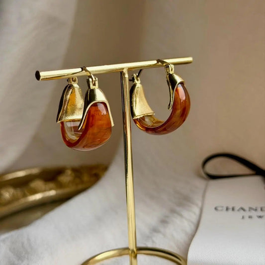 Amber Tortoiseshell Resin Chunky Hoop Drop Earrings on neutral background — front view