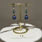 Teal & Blue Dual Crystal Drop Earrings Silver Tone on neutral background — front view