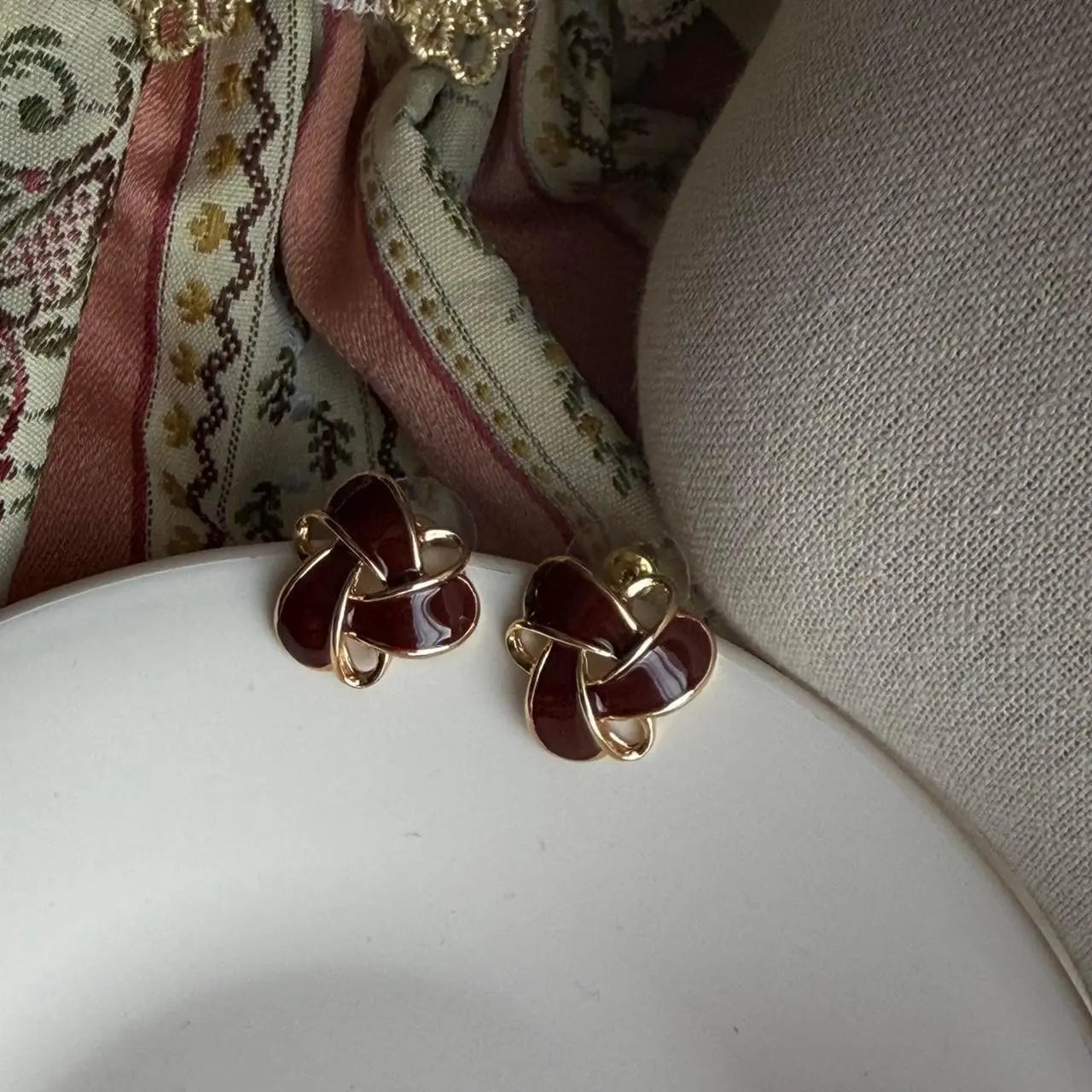 Burgundy Enamel Knot Stud Earrings S925 Gold Tone — worn on model, side profile