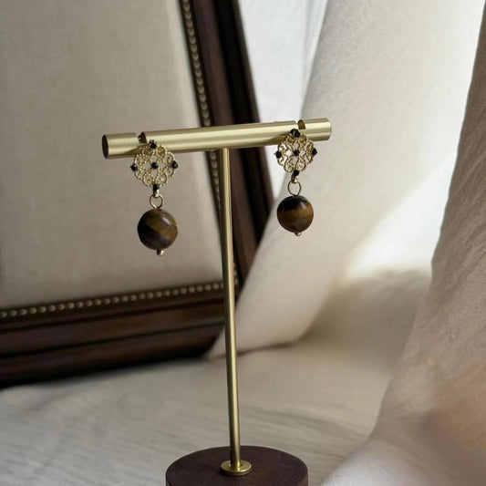 Natural Tiger Eye Drop Earrings Gold Tone Women on neutral background — front view