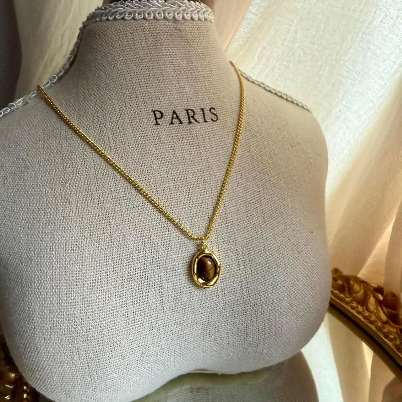 Natural Tiger Eye Oval Pendant Necklace Gold Plated on neutral background — full length view