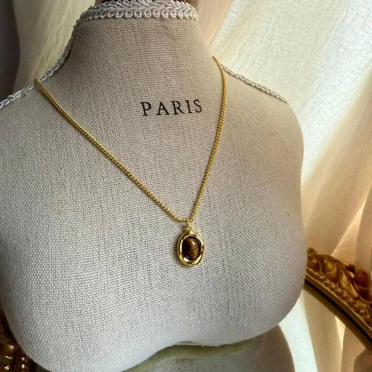 Natural Tiger Eye Oval Pendant Necklace Gold Plated on neutral background — full length view