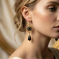 Art Deco Black Crystal Filigree Drop Earrings Gold on neutral background — front view