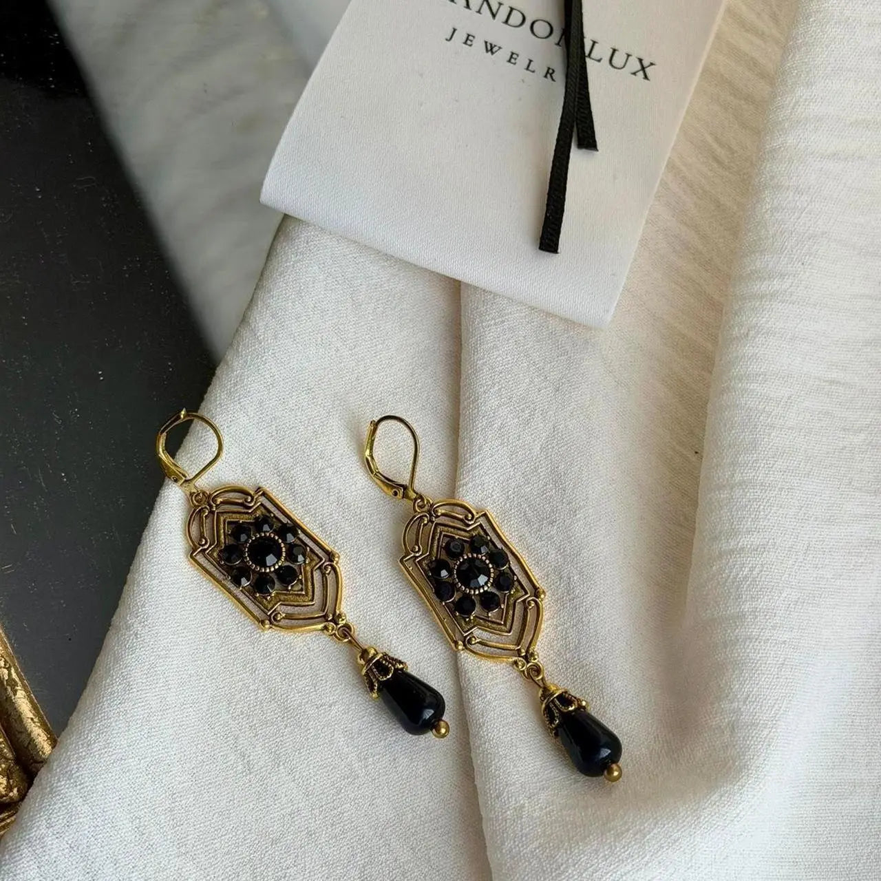 Art Deco Black Crystal Filigree Drop Earrings Gold — pair shown together on flat lay