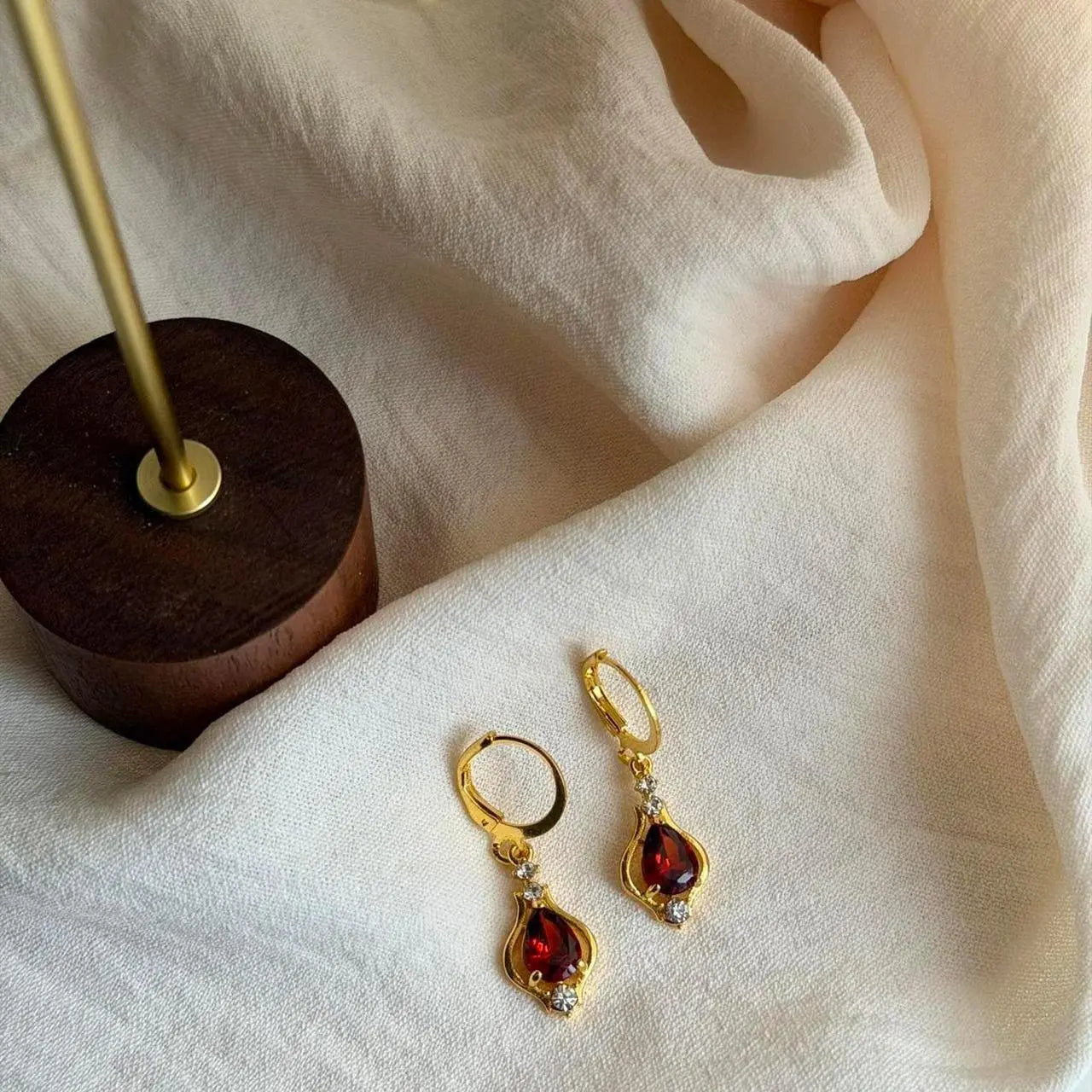Ruby Red Crystal Huggie Drop Earrings Gold Tone — close-up of pearl and post detail