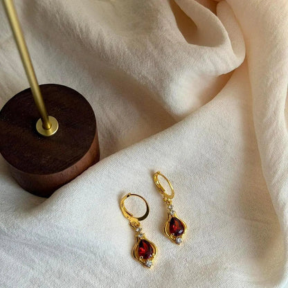 Ruby Red Crystal Huggie Drop Earrings Gold Tone — close-up of pearl and post detail