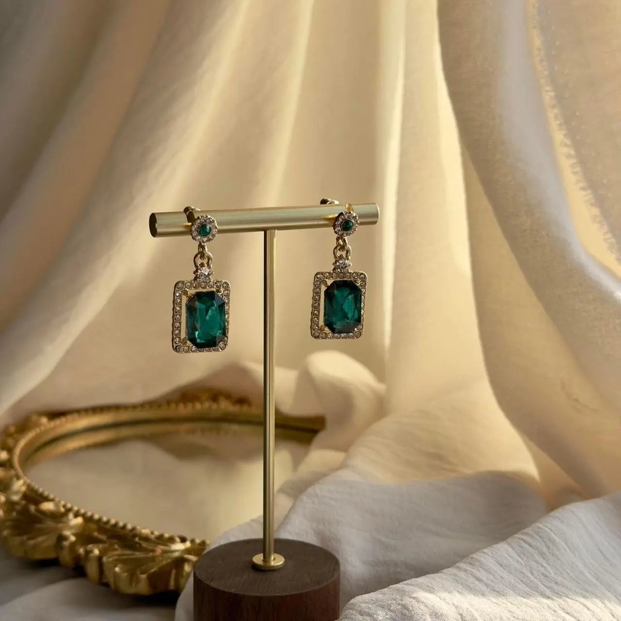 Emerald Green Rectangle Crystal Drop Earrings Gold on neutral background — front view