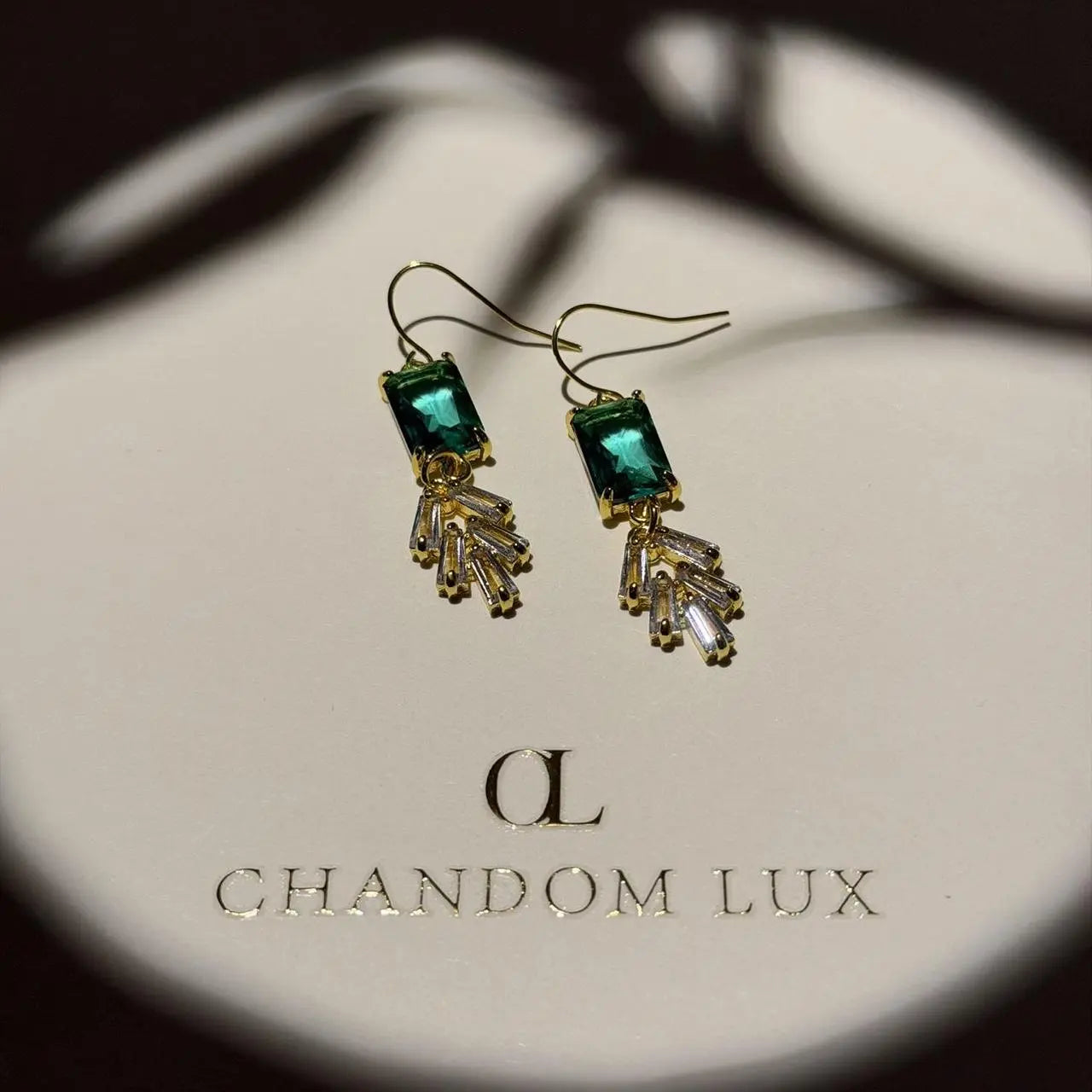 Emerald Cut Green Crystal Fan Drop Earrings Gold on neutral background — front view