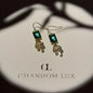 Emerald Cut Green Crystal Fan Drop Earrings Gold on neutral background — front view