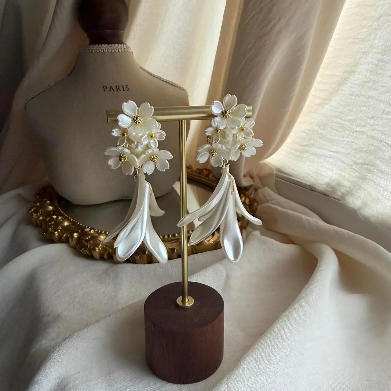 Layered White Floral Drop Earrings Gold Tone Women on neutral background — front view