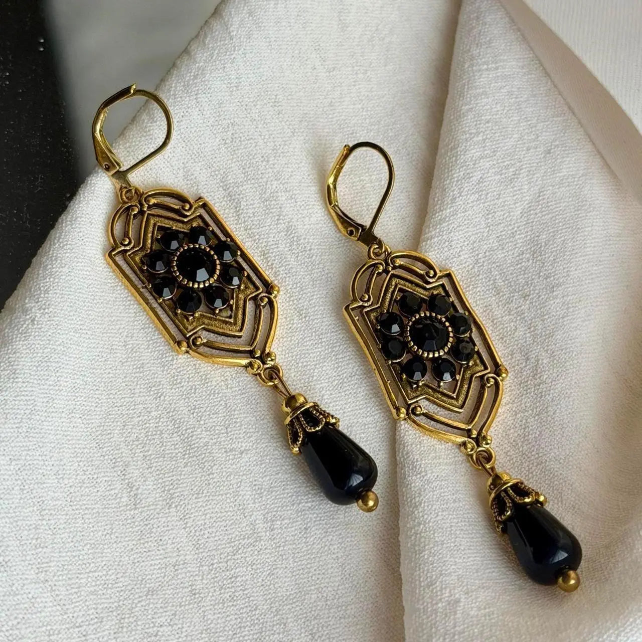 Art Deco Black Crystal Filigree Drop Earrings Gold — angle highlighting drop and movement
