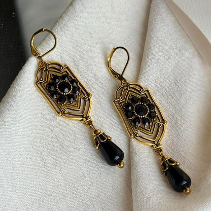 Art Deco Black Crystal Filigree Drop Earrings Gold — angle highlighting drop and movement