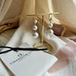 Triple Graduated Pearl Drop Earrings S925 Gold on neutral background — front view